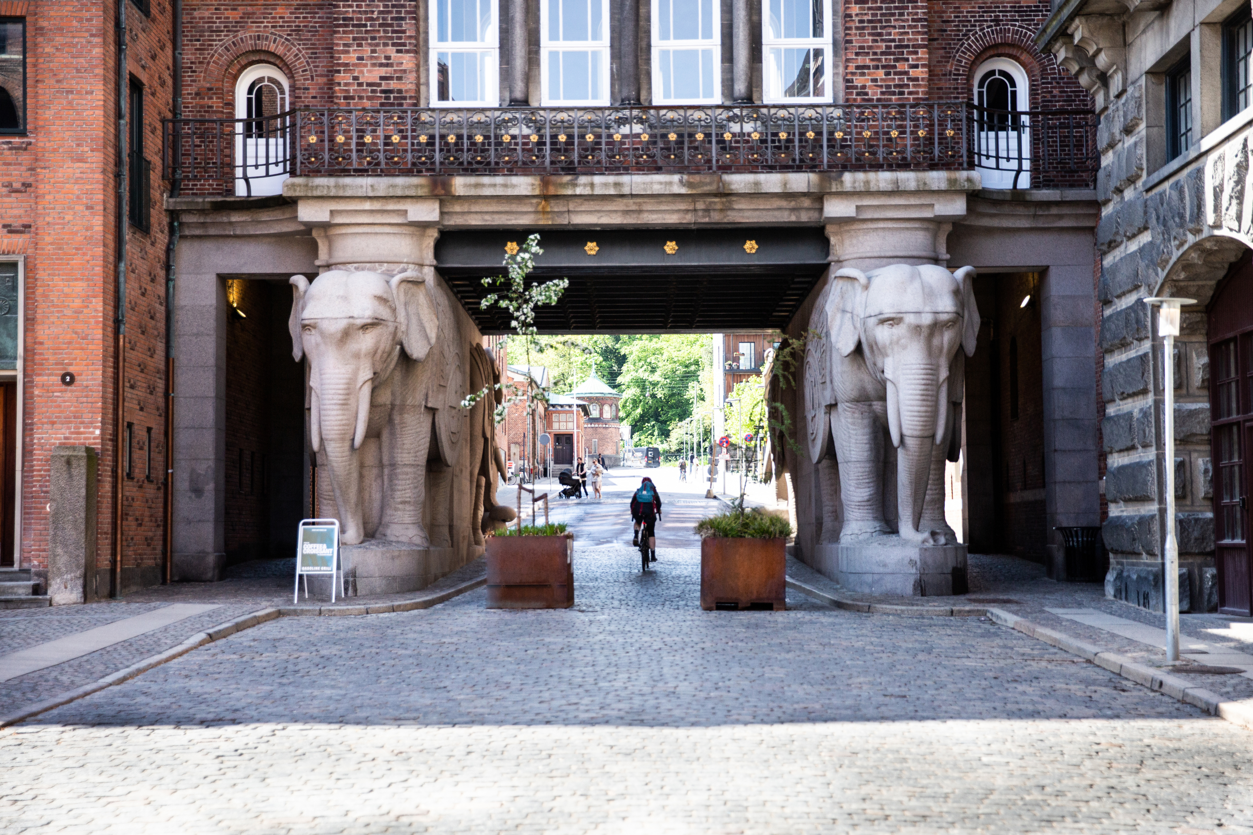 Two women sitting at a modern table talking with a city view behind them.